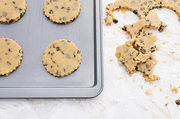 Image showing Four chocolate chip cookies on a baking tray