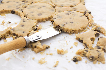 Image showing Palette knife lifting cookies from kitchen worktop