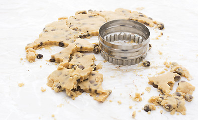 Image showing Cookie cutter with chocolate chip dough