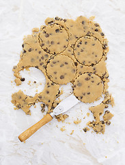 Image showing Circles in chocolate chip cookie dough with palette knife