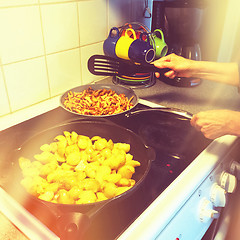 Image showing Frying potatoes and chanterelle mushrooms