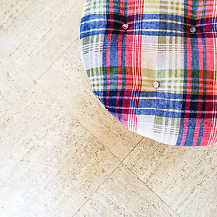 Image showing Checked velvet stool on tiled floor