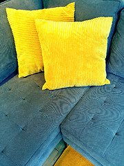 Image showing Blue sofa with bright yellow cushions