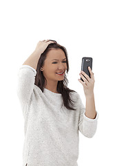 Image showing Woman Using a Smartphone Like a Mirror