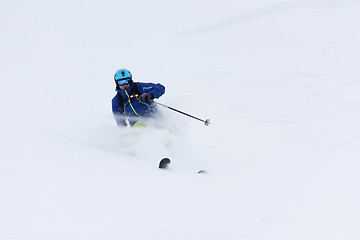 Image showing freeride skier skiing in deep powder snow