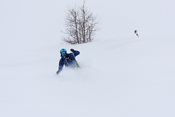 Image showing freeride skier skiing in deep powder snow