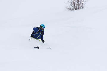 Image showing freeride skier skiing in deep powder snow