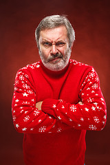 Image showing The expressive portrait on red background of a pouter man 