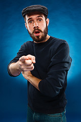 Image showing Young man in cap, finger pointing towards the camera 