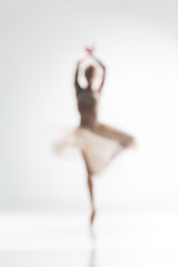 Image showing Blurred silhouette of ballerina on white background