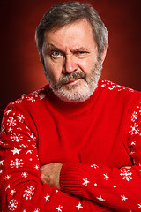 Image showing The expressive portrait on red background of a pouter man 