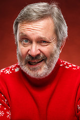 Image showing The expressive portrait on red background of a pouter man 