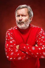 Image showing The expressive portrait on red background of a pouter man 