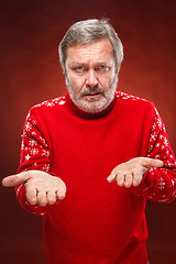 Image showing The expressive portrait on red background of a pouter man 