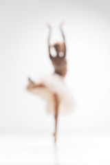 Image showing Blurred silhouette of ballerina on white background