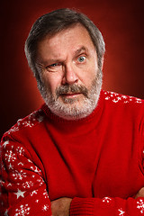 Image showing The expressive portrait on red background of a pouter man 