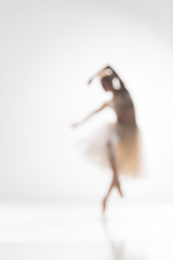 Image showing Blurred silhouette of ballerina on white background