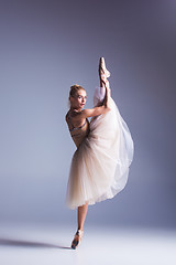 Image showing Young beautiful modern style dancer posing on a studio background