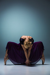 Image showing Young beautiful modern style dancer posing on a studio background