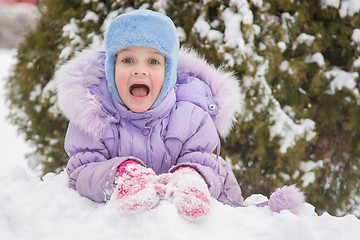 Image showing  Girl lying in a snowdrift snow