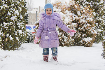 Image showing Joyful five years girl goes on snowdrifts