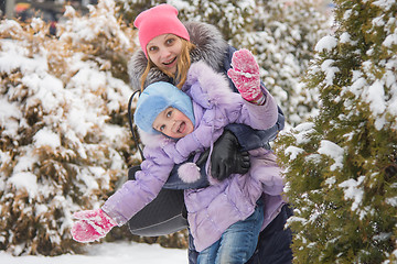 Image showing Mom and daughter having fun five-year look out for trees