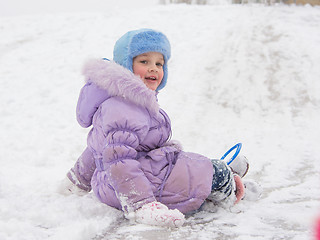 Image showing  Girl with snow-covered rolling hills backwards