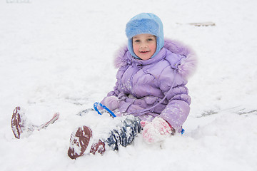 Image showing Happy little girl slid down the icy hill