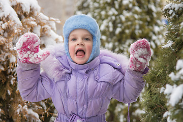 Image showing Girl afraid of jumping out of the snow-covered trees