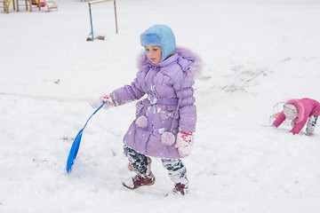 Image showing  Girl wearily climbs icy hill