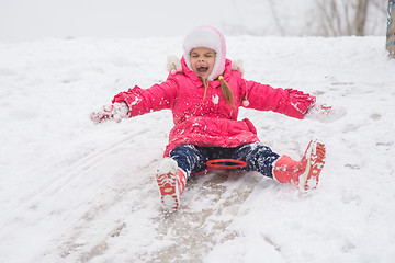 Image showing Girl closing her eyes and opening the ice kind of rolling hills
