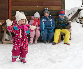 Image showing little children group sitting  together  in front of wooden cabi