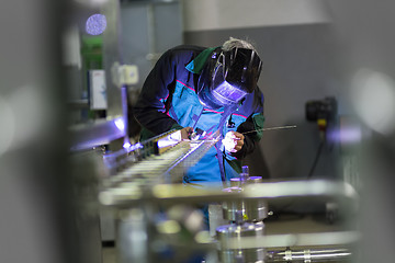 Image showing Industrial worker welding in metal factory.