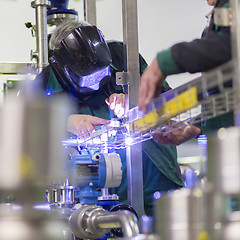 Image showing Industrial worker welding in metal factory.