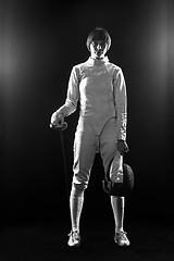 Image showing The portrait of woman wearing white fencing costume  on black 