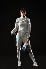 Image showing The portrait of woman wearing white fencing costume  on black 