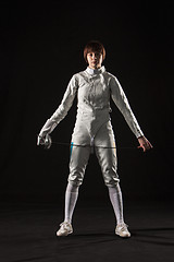 Image showing The portrait of woman wearing white fencing costume  on black 