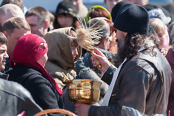 Image showing Priest blessing people with holy water. Tyumen