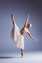 Image showing Young beautiful ballerina dancer dancing on a studio background