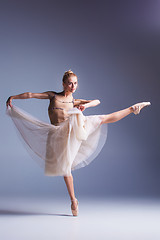 Image showing Young beautiful ballerina dancer dancing on a studio background