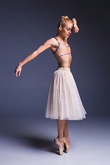 Image showing Young beautiful ballerina dancer dancing on a studio background