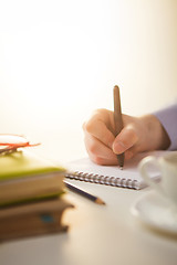 Image showing The male hand with a pen and the cup