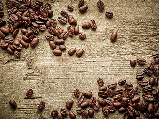 Image showing Coffee beans on wooden table