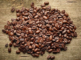 Image showing Coffee beans on wooden table