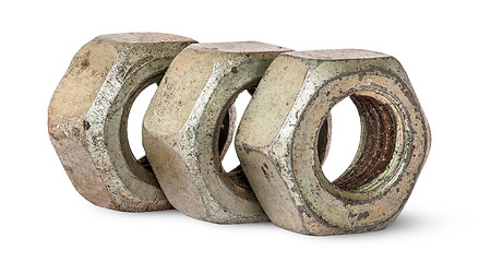 Image showing Three old rusty nuts in a row rotated