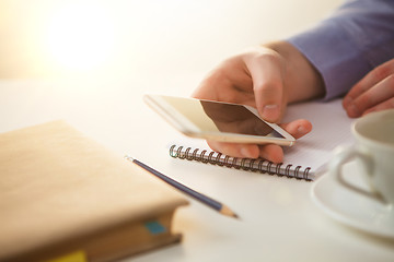 Image showing The male hand holding a phone 