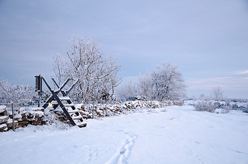 Image showing Winterland with a stile at a stone wall