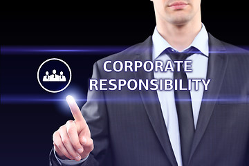 Image showing business, technology and networking concept - businessman pressing corporate responsibility button on virtual screens