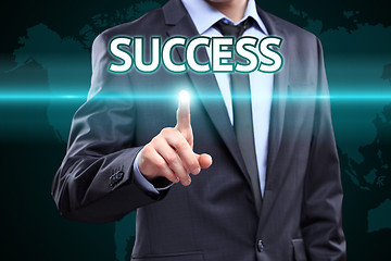 Image showing businessman hand pushing success button on a touch screen interface. Business,  technology concept.