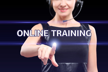 Image showing business, technology, internet and networking concept - businesswoman pressing online training button on virtual screens